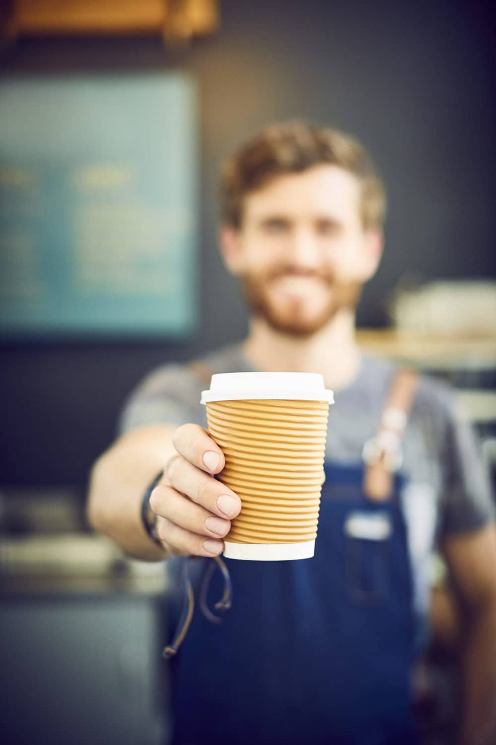 Coffee cup being held by barista